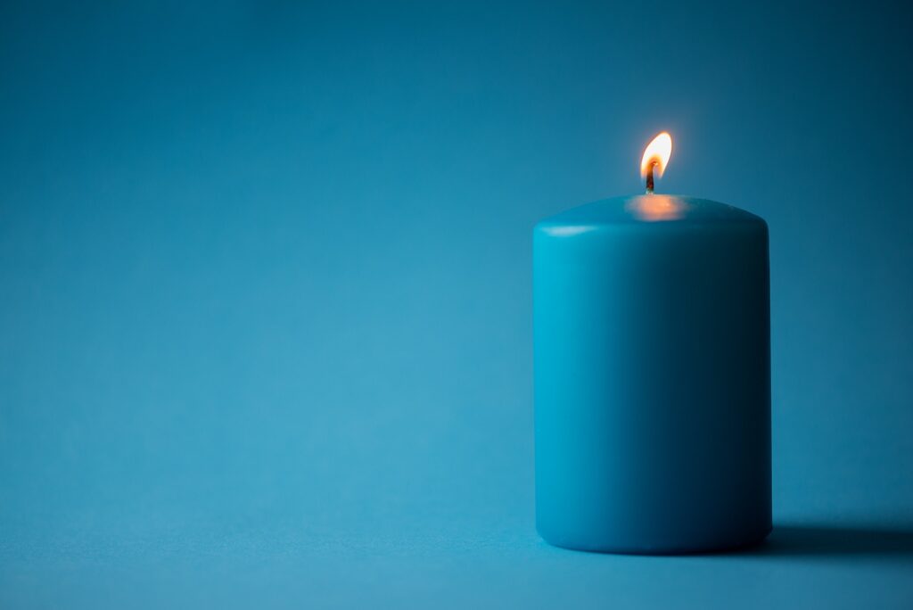 Blue candle isolated on blue
